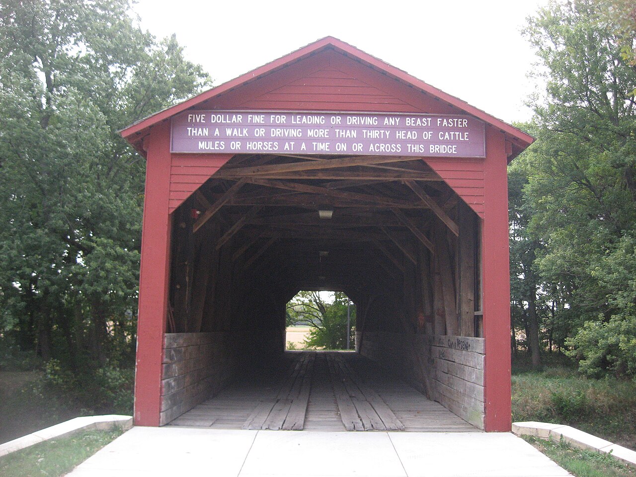 Northwestern portal of the Oquawka Wagon Bridge , which spans Henderson Creek in a park south of Oquawka in far northern Gladstone Township , Henderson County , Illinois , United States