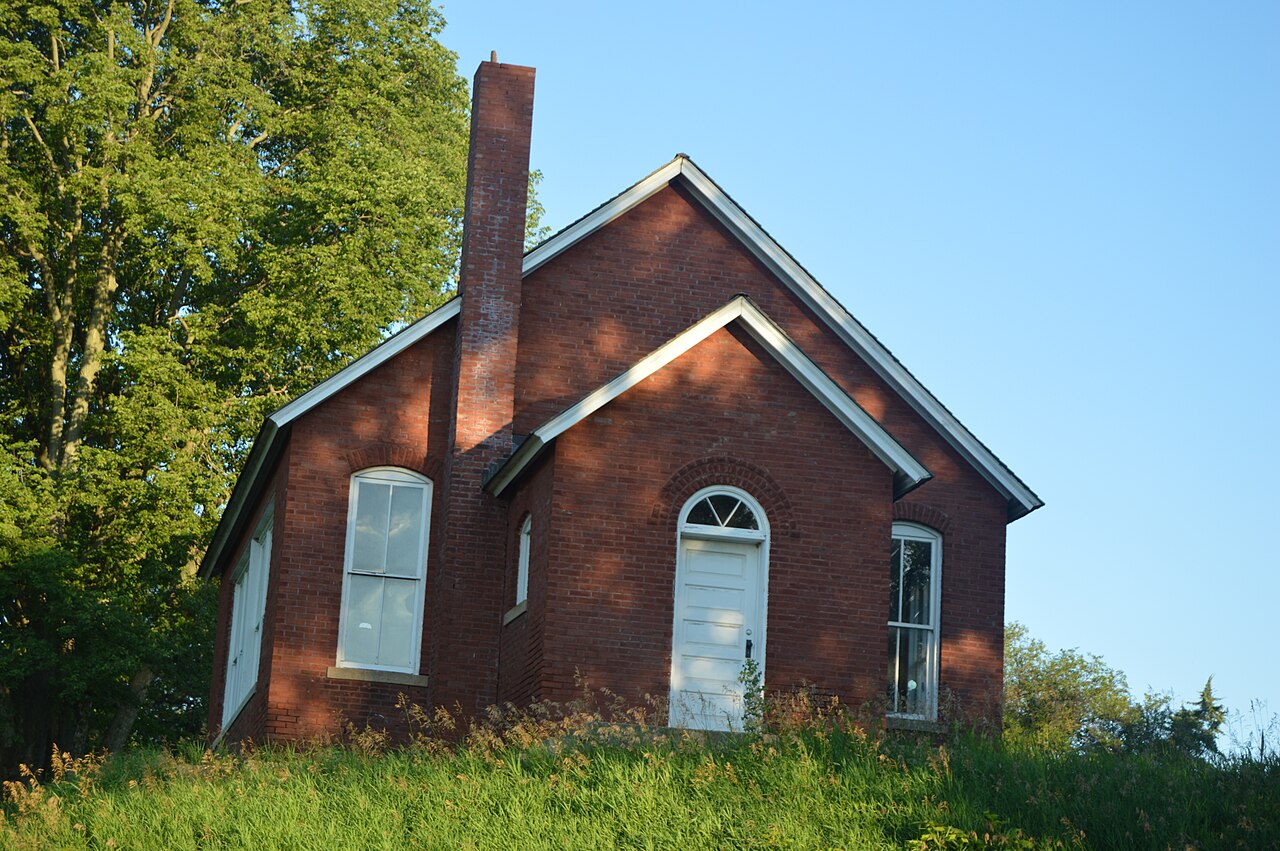 Front and southern side of the East Waterford School , located on the western side of Dickson Mounds Road at the Prairie Road intersection in Waterford Township , Fulton County , Illinois , United States
